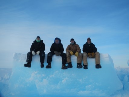 Men sitting on a block of ice